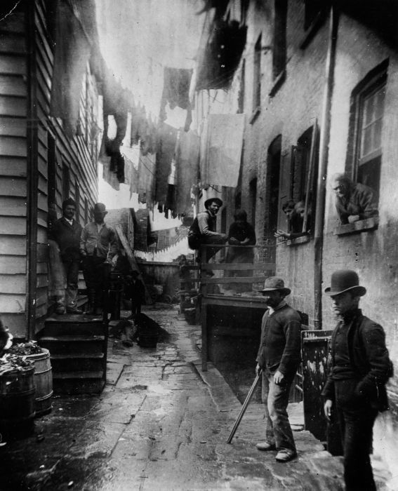 1887: A group of men loitering in an alley known as "Bandits' Roost", situated off Mulberry Street in New York City. (Photo by Jacob A. Riis/Museum of the City of New York/Getty Images)